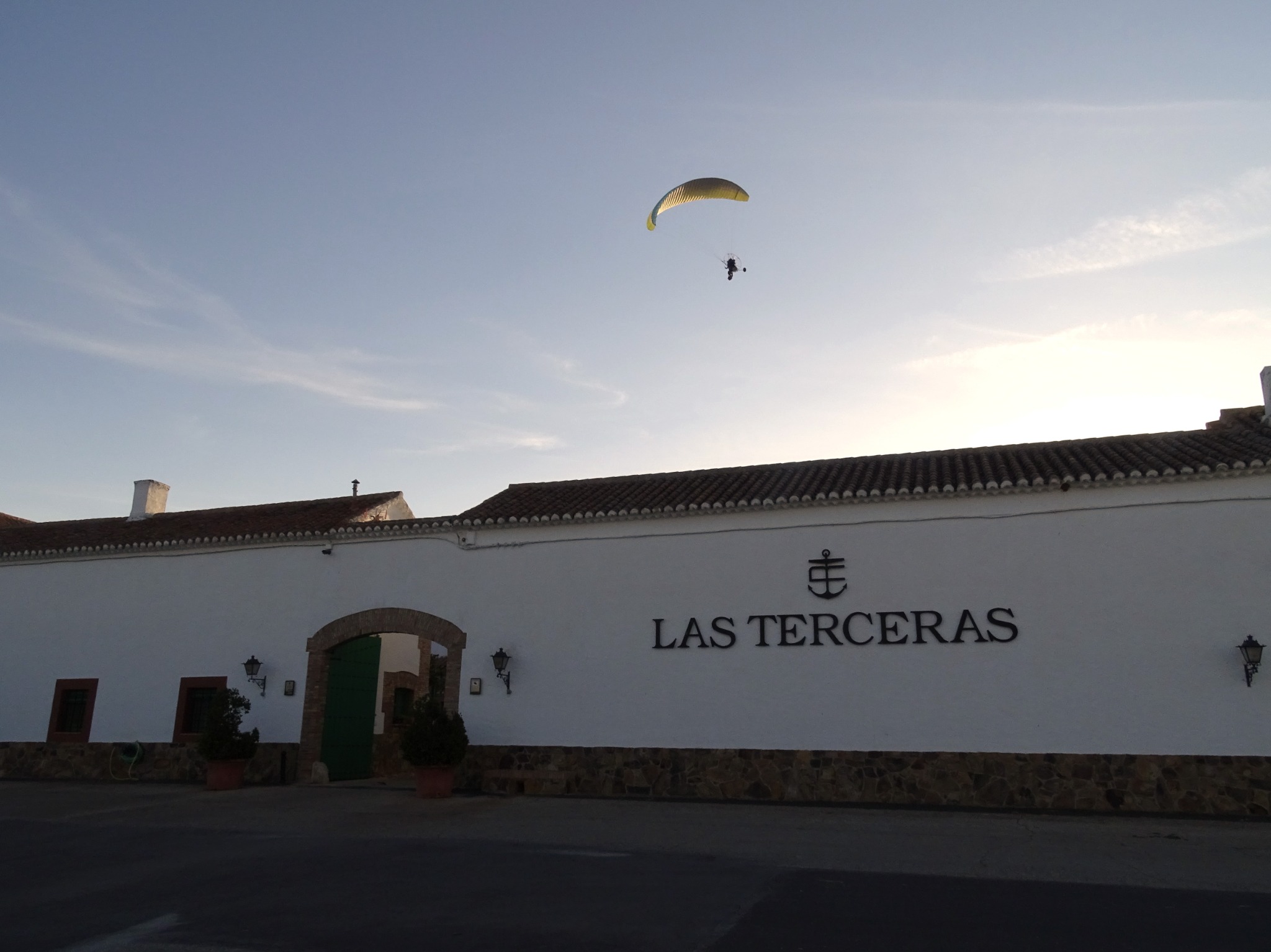 A paramotor flies above the facade of Finca Las Terceras