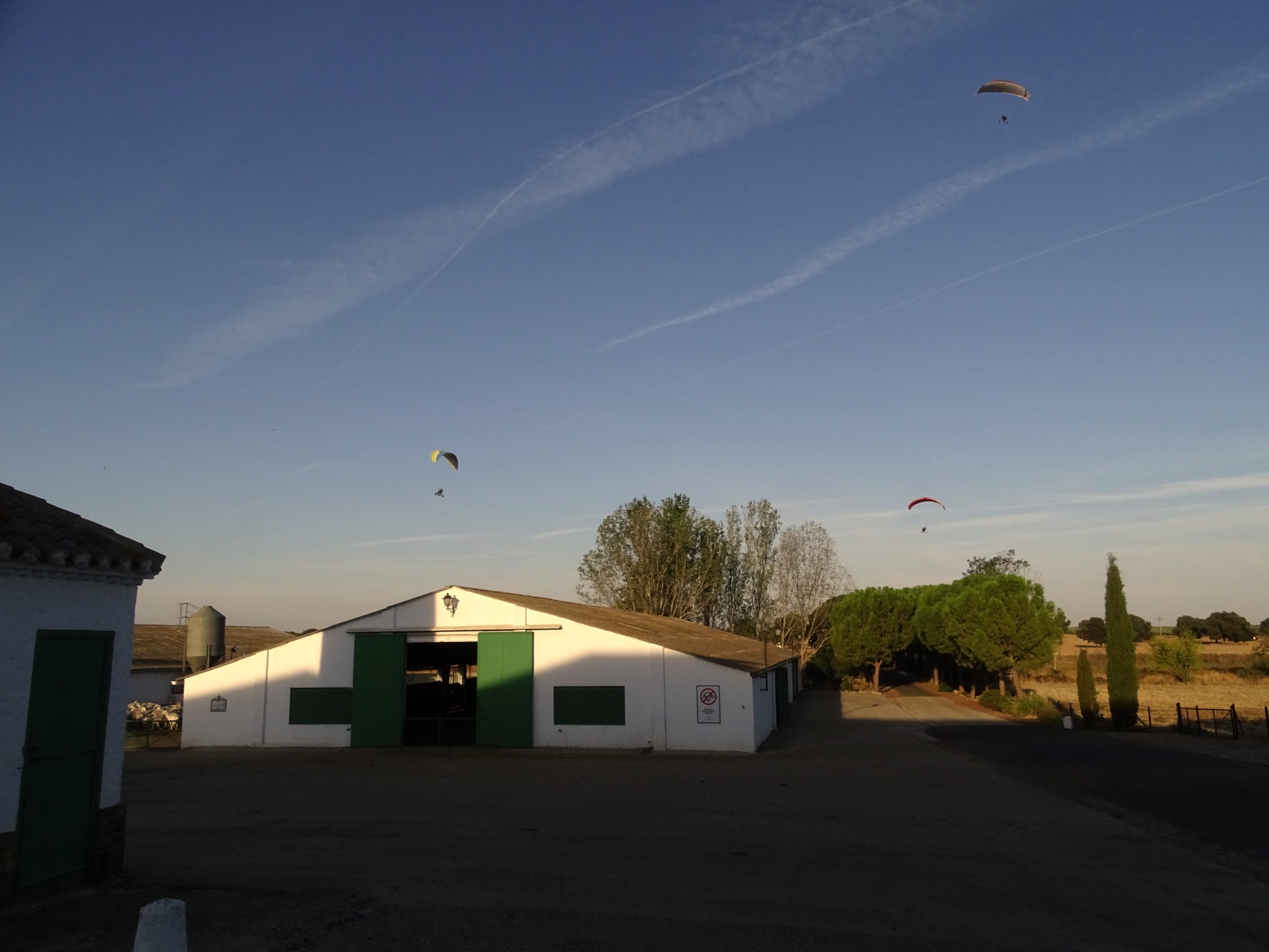 Paramotors above the buildings and fields of Finca Las Terceras