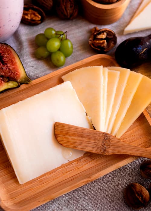 Manchego cheese board with fruit, walnuts and honey